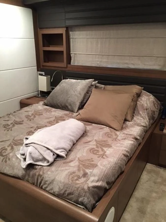 a bed with pillows aboard HEAL Yacht for Sale