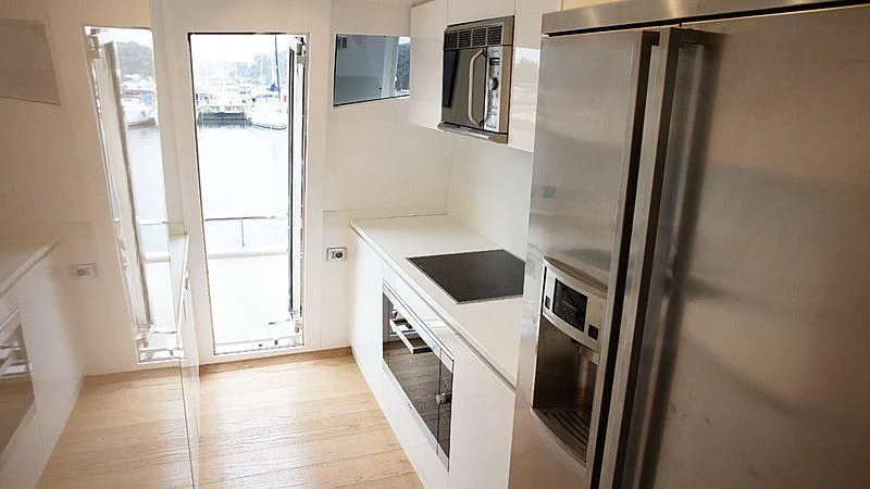 a kitchen with a refrigerator and microwave aboard ALDA 2 Yacht for Sale