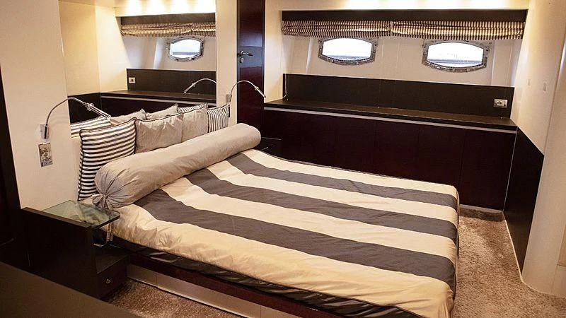 a bed with a black and white striped bed spread aboard ALDA 2 Yacht for Sale