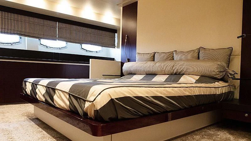 a bed with a black headboard aboard ALDA 2 Yacht for Sale