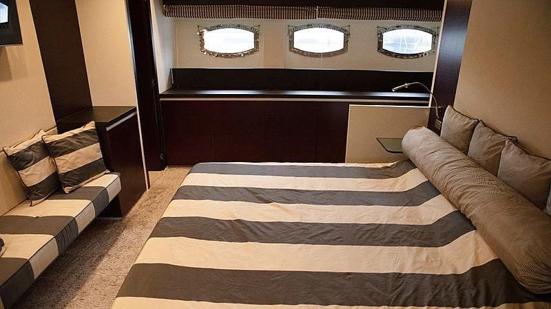 a bed with a black and white striped blanket and a black and white striped pillow aboard ALDA 2 Yacht for Sale