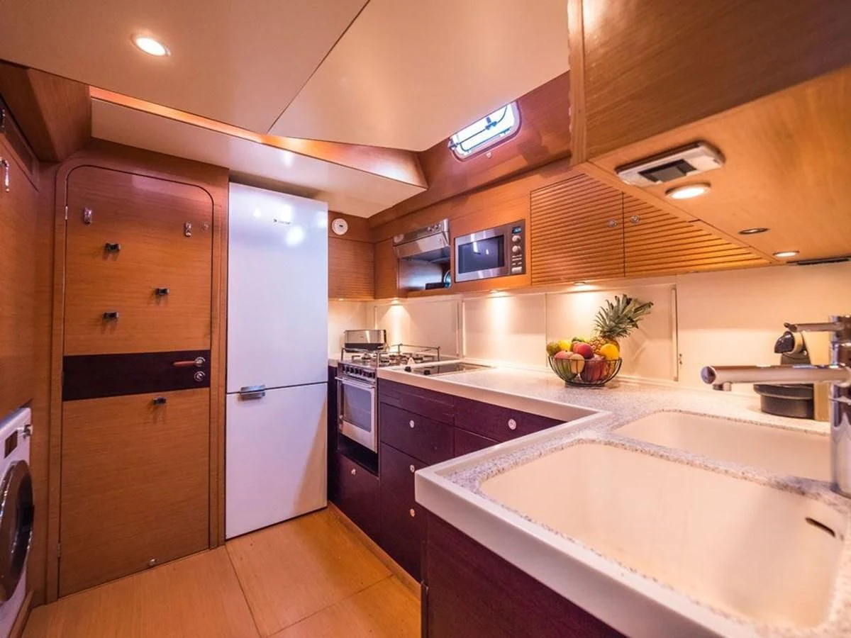 a kitchen with a large wooden door aboard KALINDA Yacht for Sale