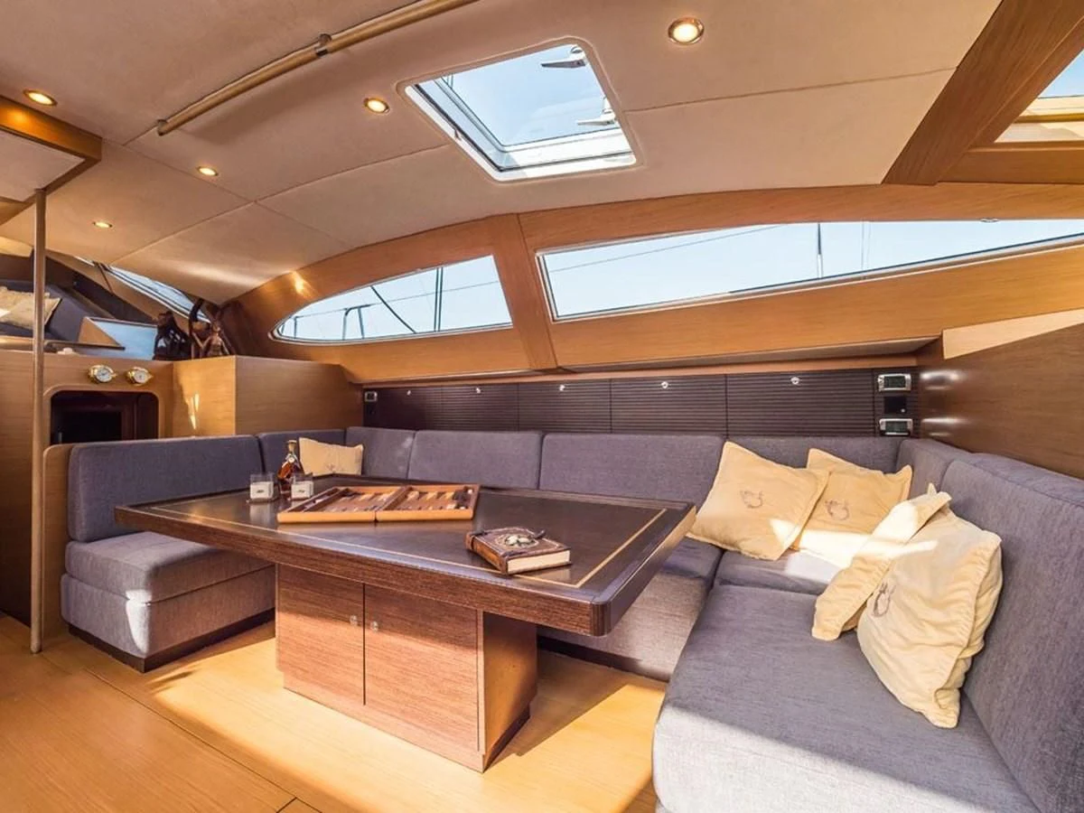 a living room with a couch and a coffee table aboard KALINDA Yacht for Sale