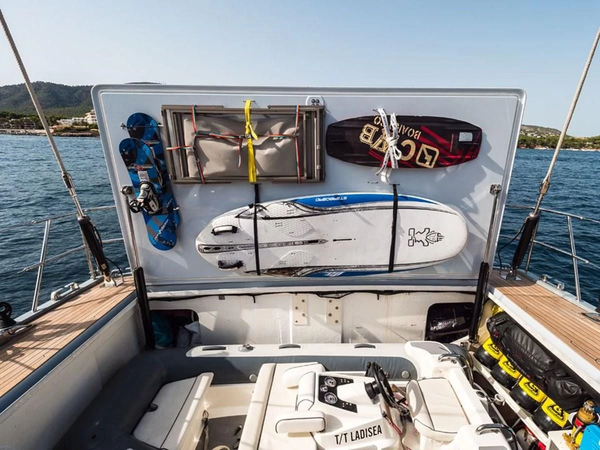 a boat with a surfboard on it aboard KALINDA Yacht for Sale