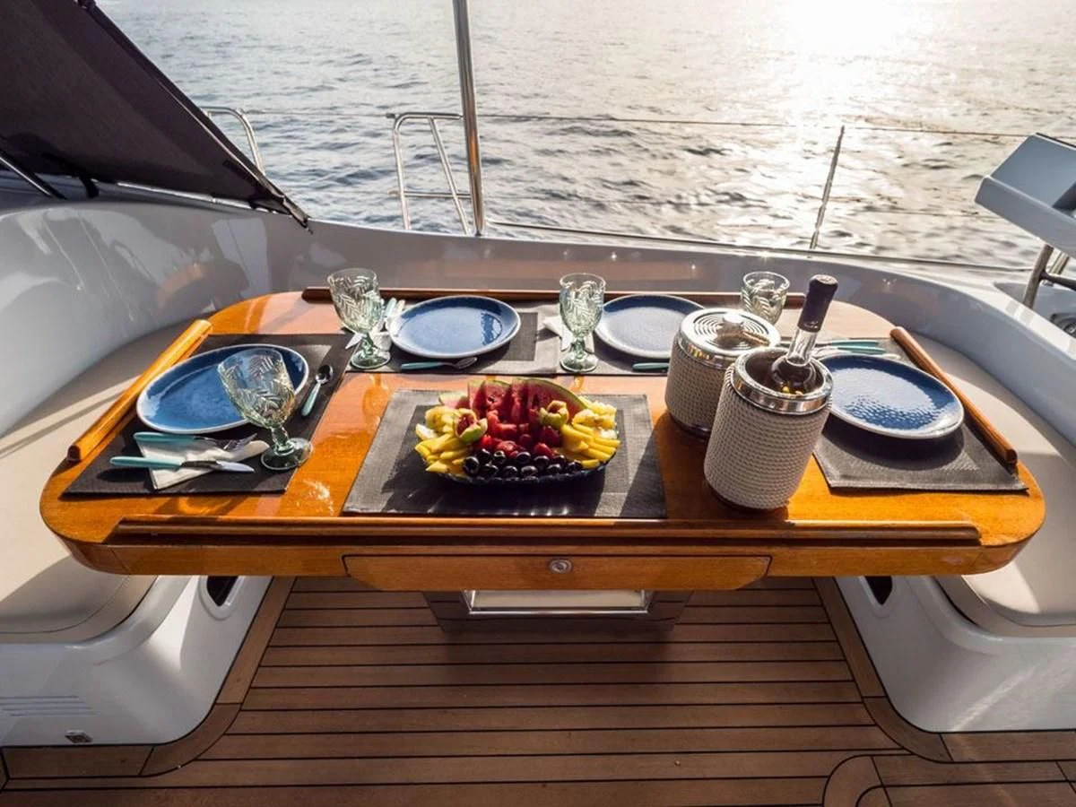 a table with food and drinks on it aboard KALINDA Yacht for Sale