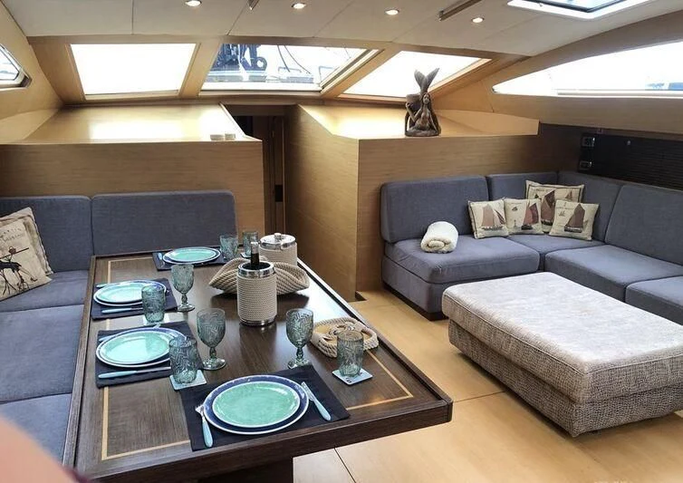 a living room with a couch and a coffee table aboard KALINDA Yacht for Sale