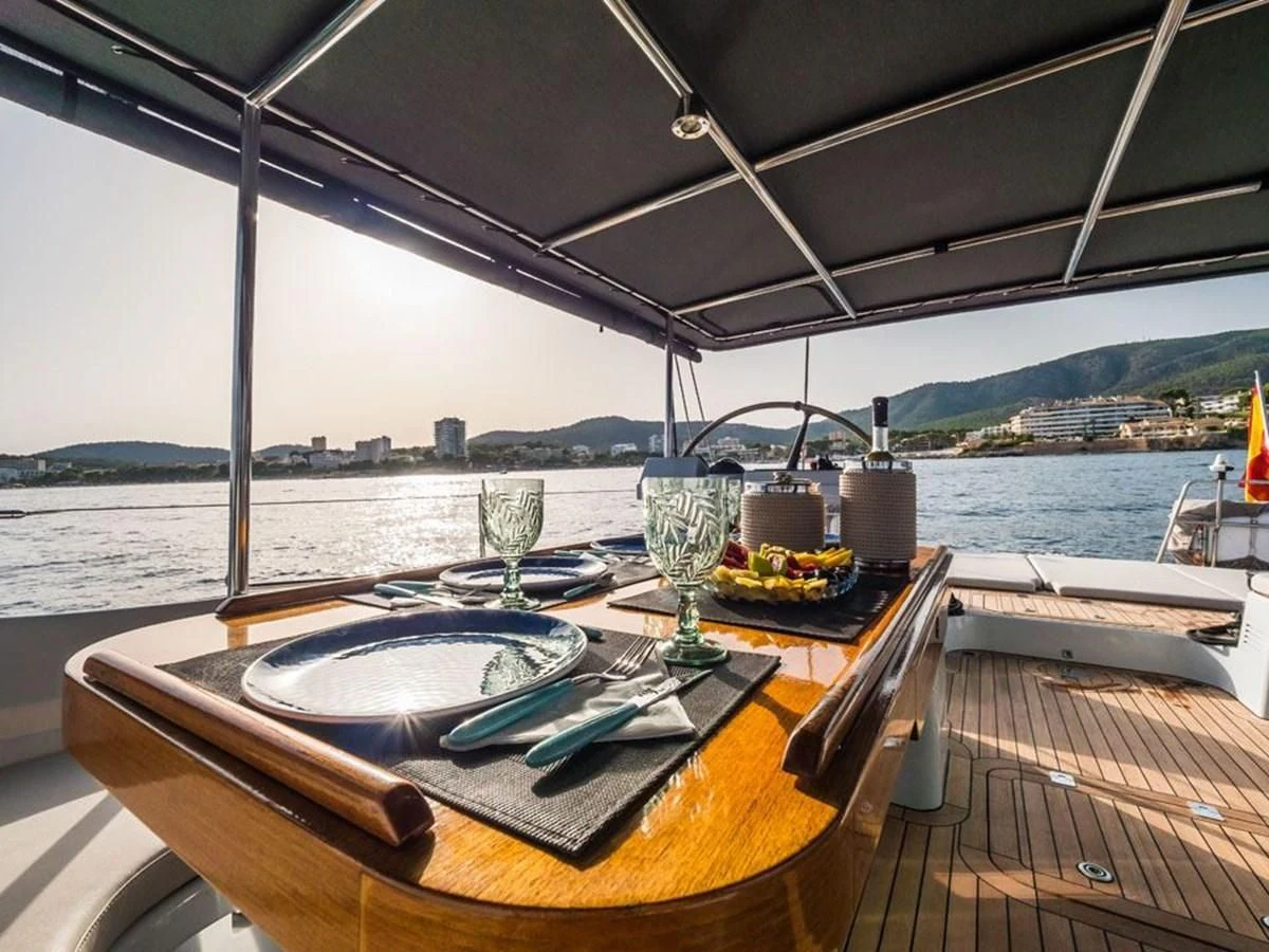 a table with plates and glasses on it aboard KALINDA Yacht for Sale