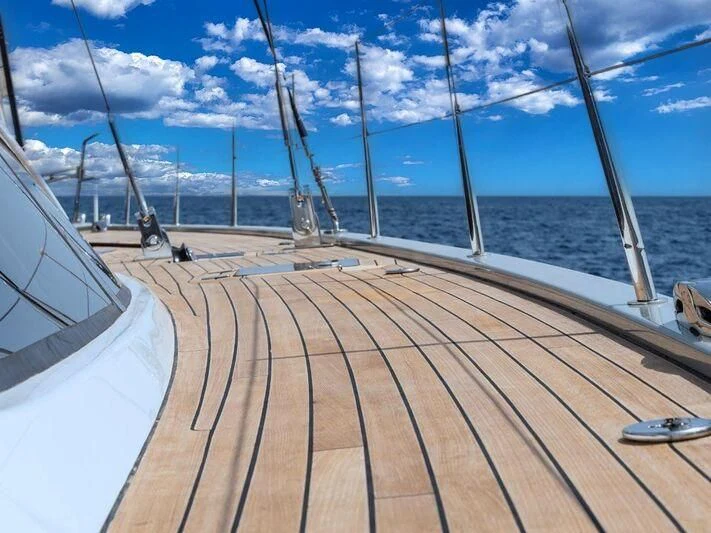 a deck with a view of the ocean and a boat aboard KALINDA Yacht for Sale