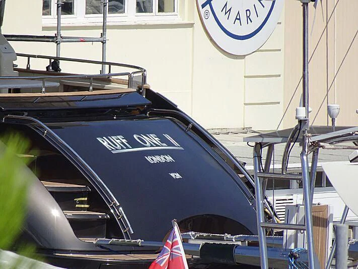 a black car with a blue hood aboard RUFF ONE II Yacht for Sale