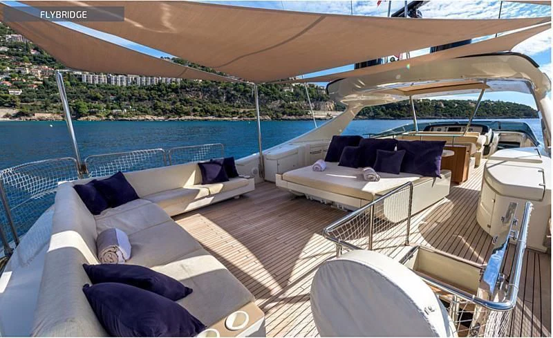 a large white tent with a couch and a table and chairs aboard RUFF ONE II Yacht for Sale