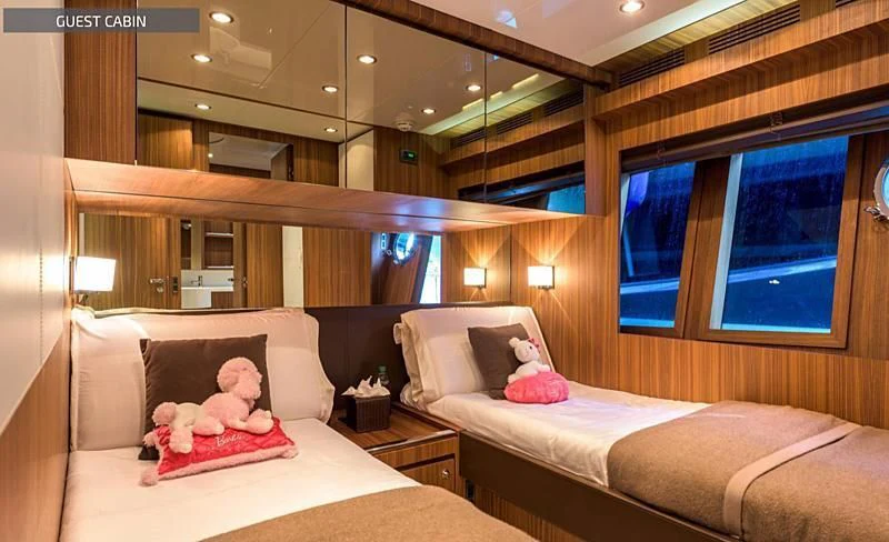 a room with a bed and a teddy bear aboard RUFF ONE II Yacht for Sale