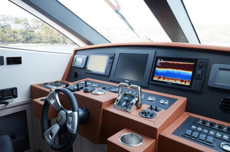 a computer desk with a large monitor and a keyboard aboard LONGREEF 90/01 SX Yacht for Sale