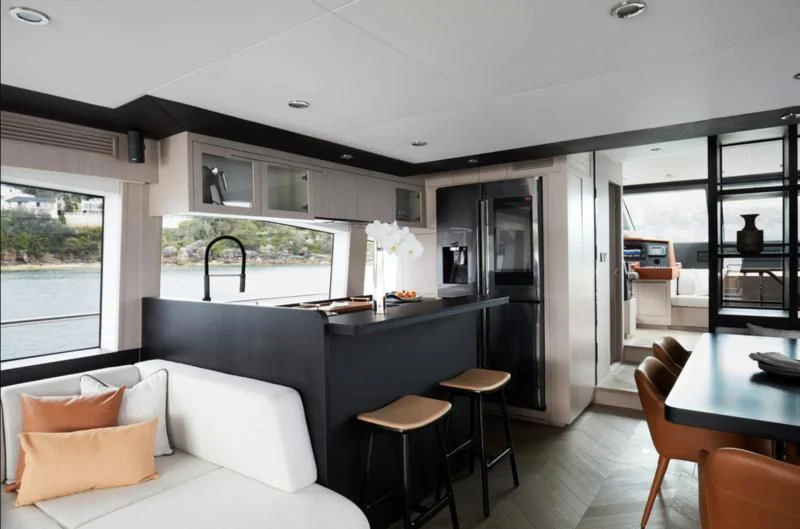 a living room with a large kitchen aboard LONGREEF 90/01 SX Yacht for Sale