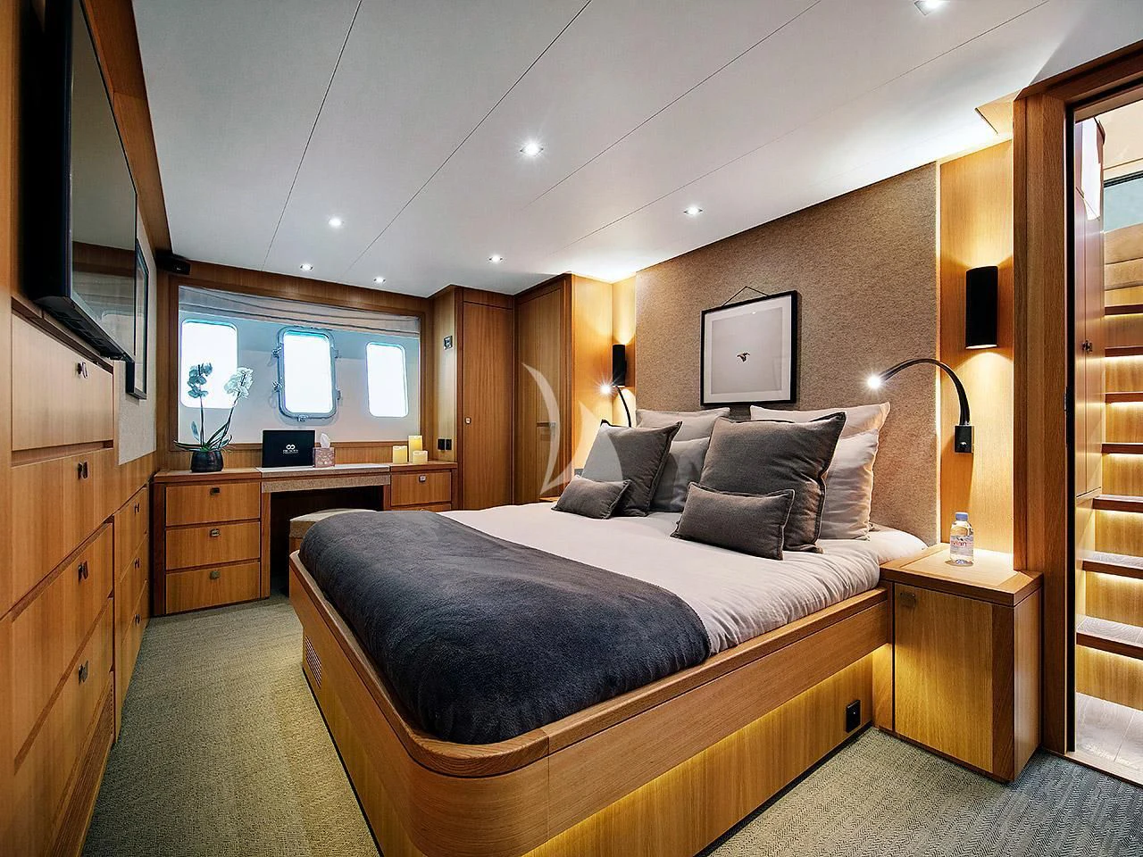 a bedroom with a bed and a desk aboard ARMONEE Yacht for Sale