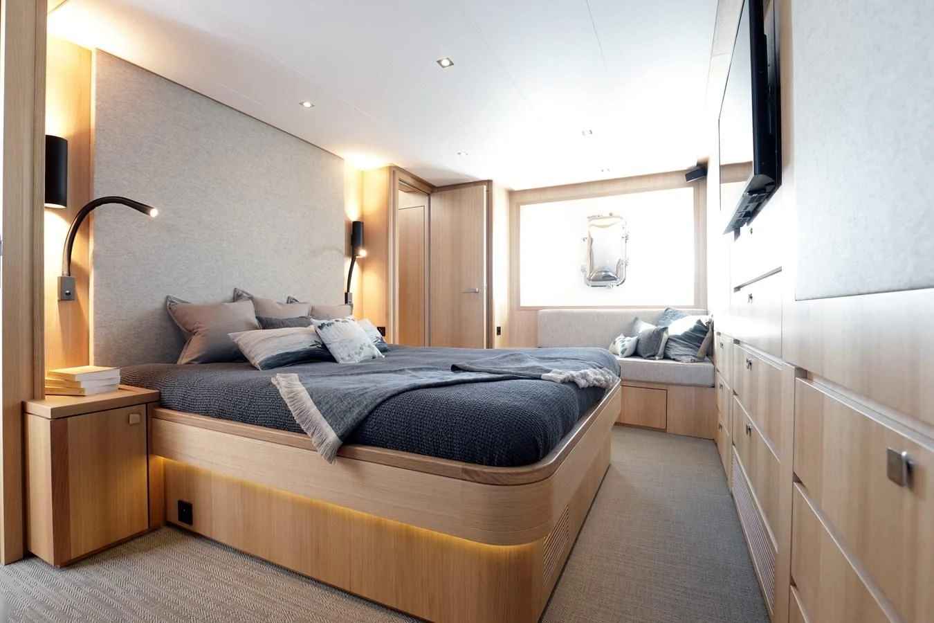 a bedroom with a bed and a mirror aboard ARMONEE Yacht for Sale
