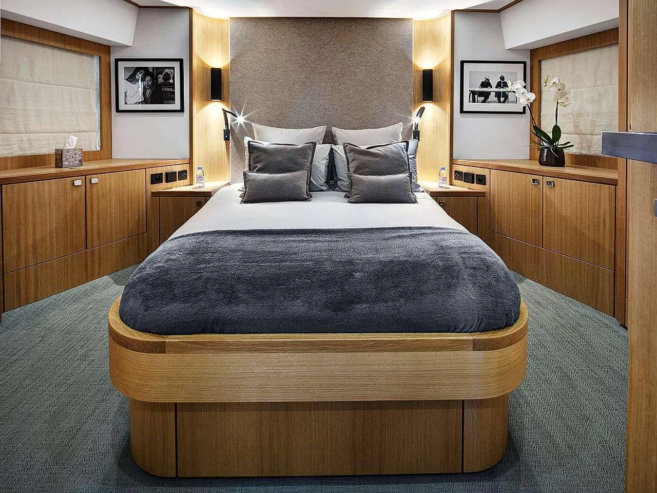 a bed with a black comforter aboard ARMONEE Yacht for Sale