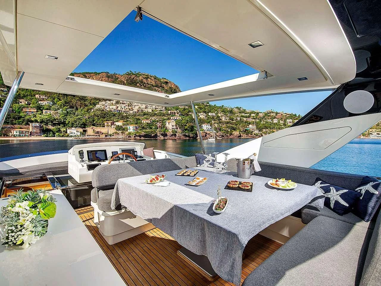 a large white tent with a table and chairs on a patio by a pool aboard ARMONEE Yacht for Sale
