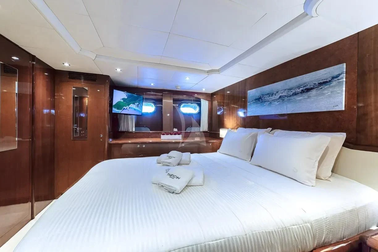 a bed with white sheets aboard THEION Yacht for Sale