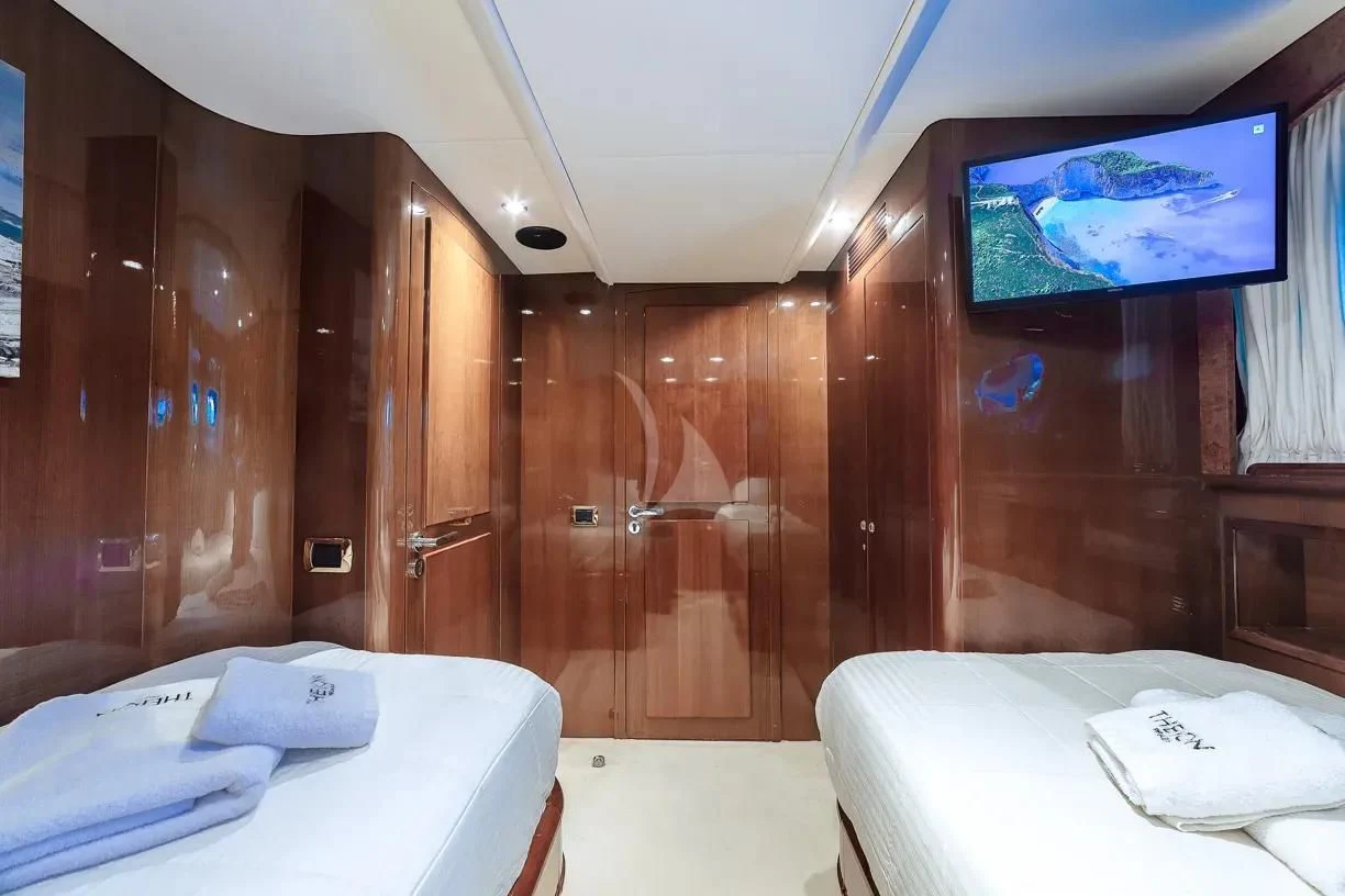 a room with a bed and a television aboard THEION Yacht for Sale