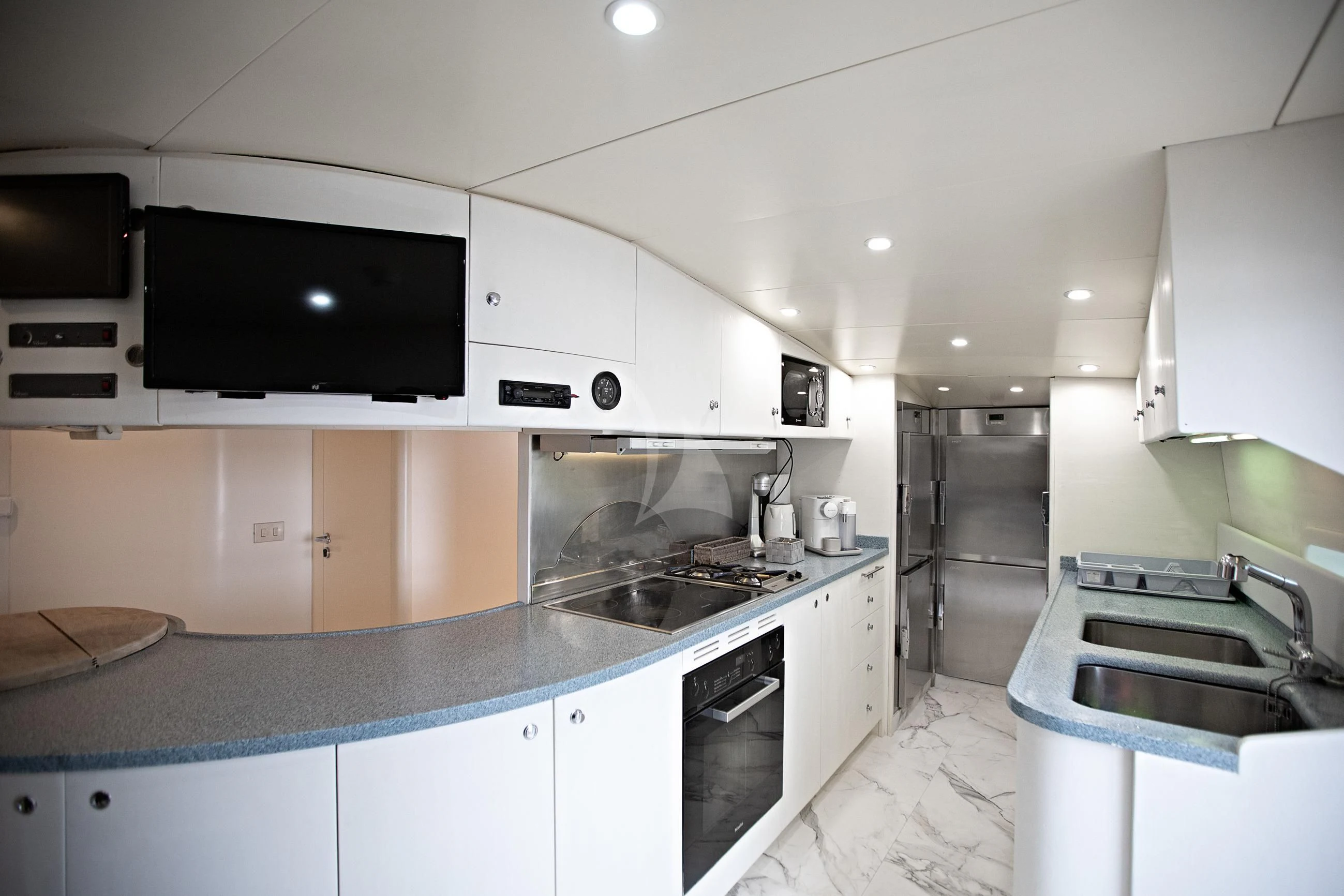 a kitchen with a microwave oven and a sink aboard THEION Yacht for Sale