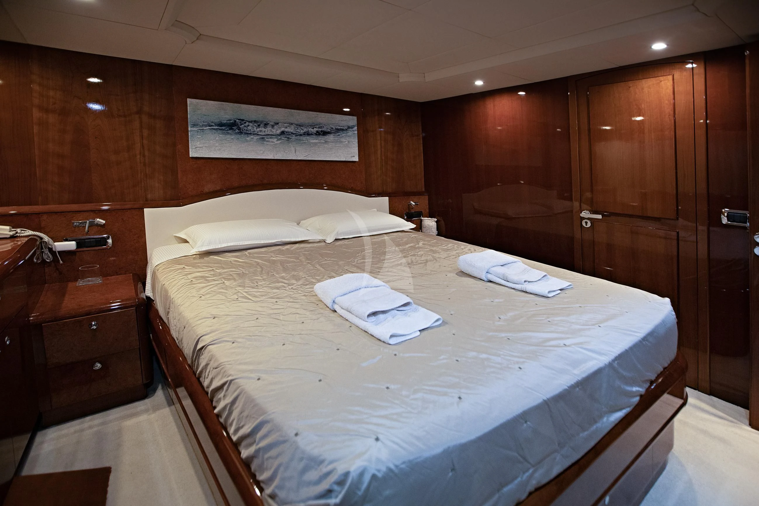 a bed with white sheets aboard THEION Yacht for Sale
