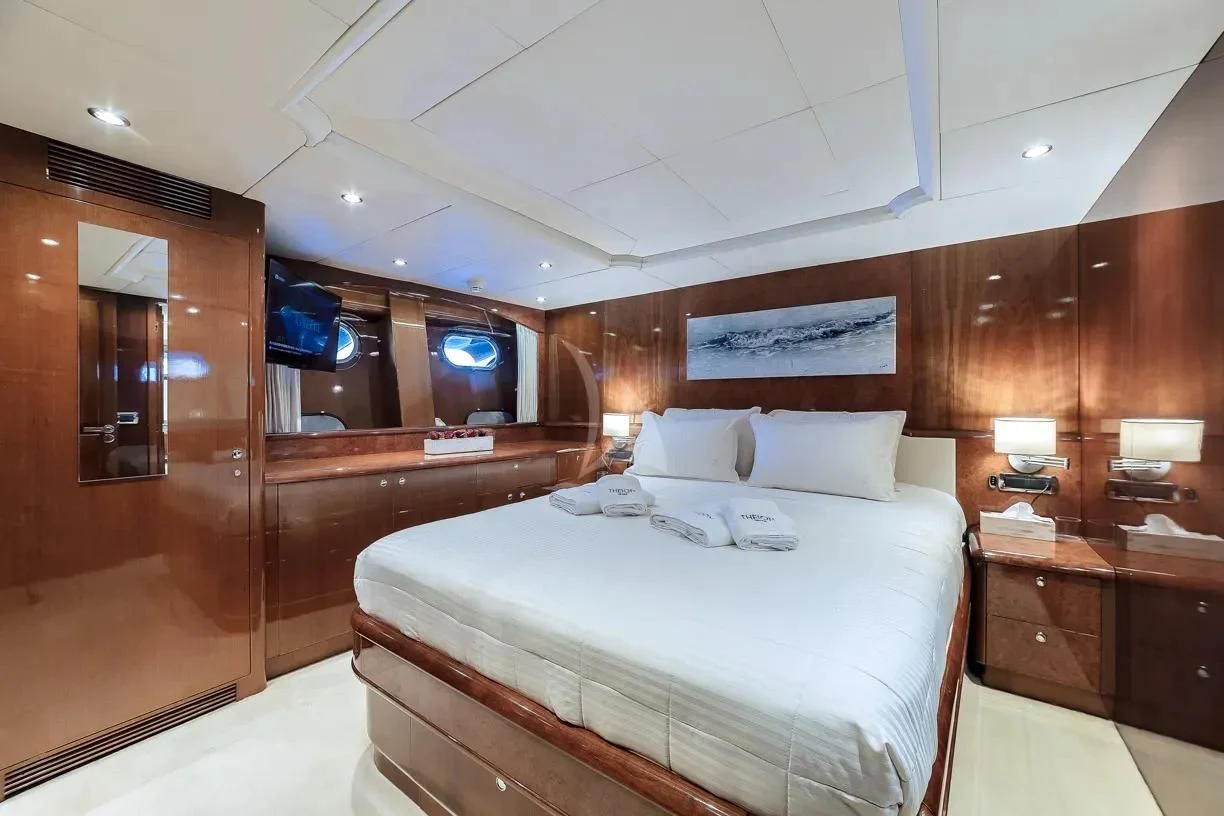 a room with a bed and a mirror aboard THEION Yacht for Sale