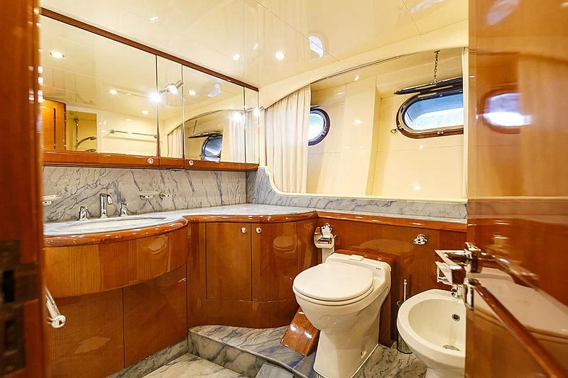 a bathroom with a toilet sink and a mirror aboard THEION Yacht for Sale
