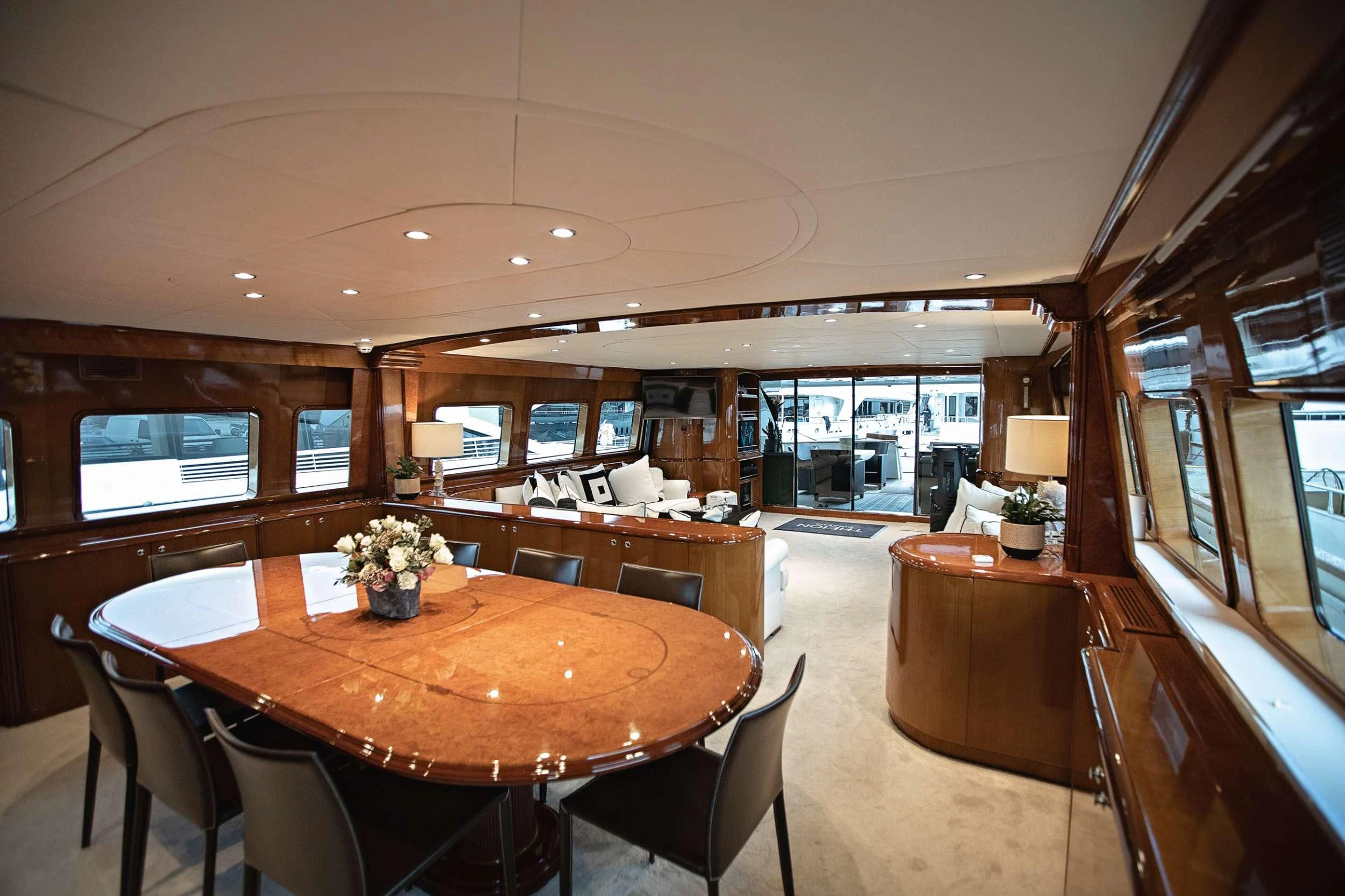 a large dining table in a large room aboard THEION Yacht for Sale