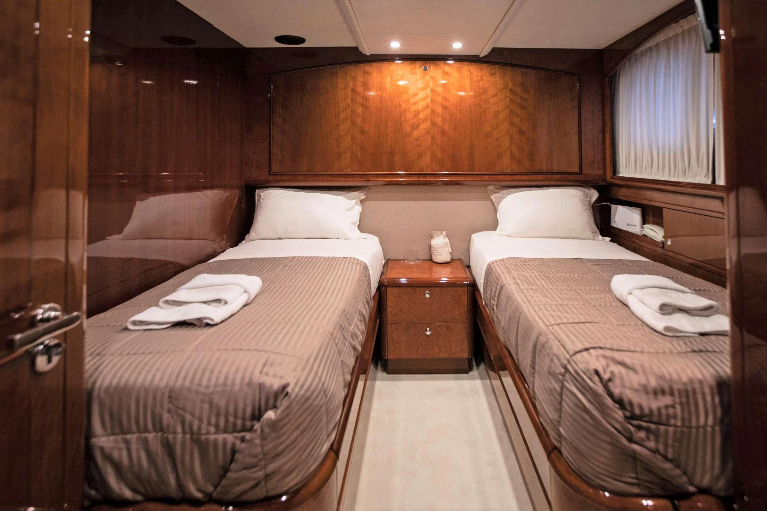 a room with two beds aboard THEION Yacht for Sale