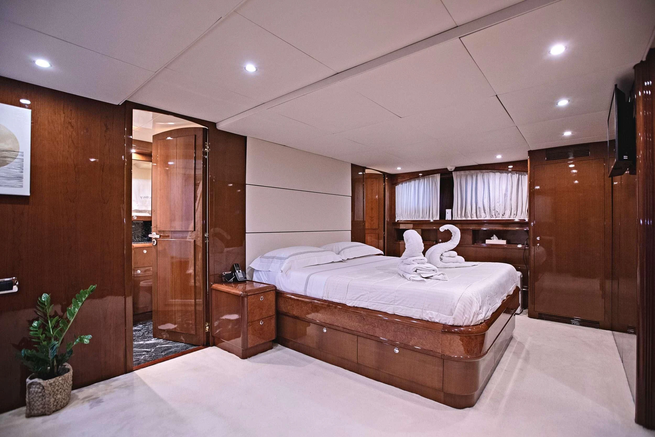 a bedroom with a bed and a closet aboard THEION Yacht for Sale