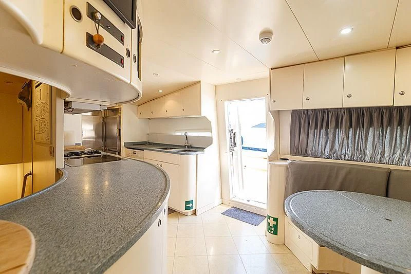a kitchen with a large island aboard THEION Yacht for Sale