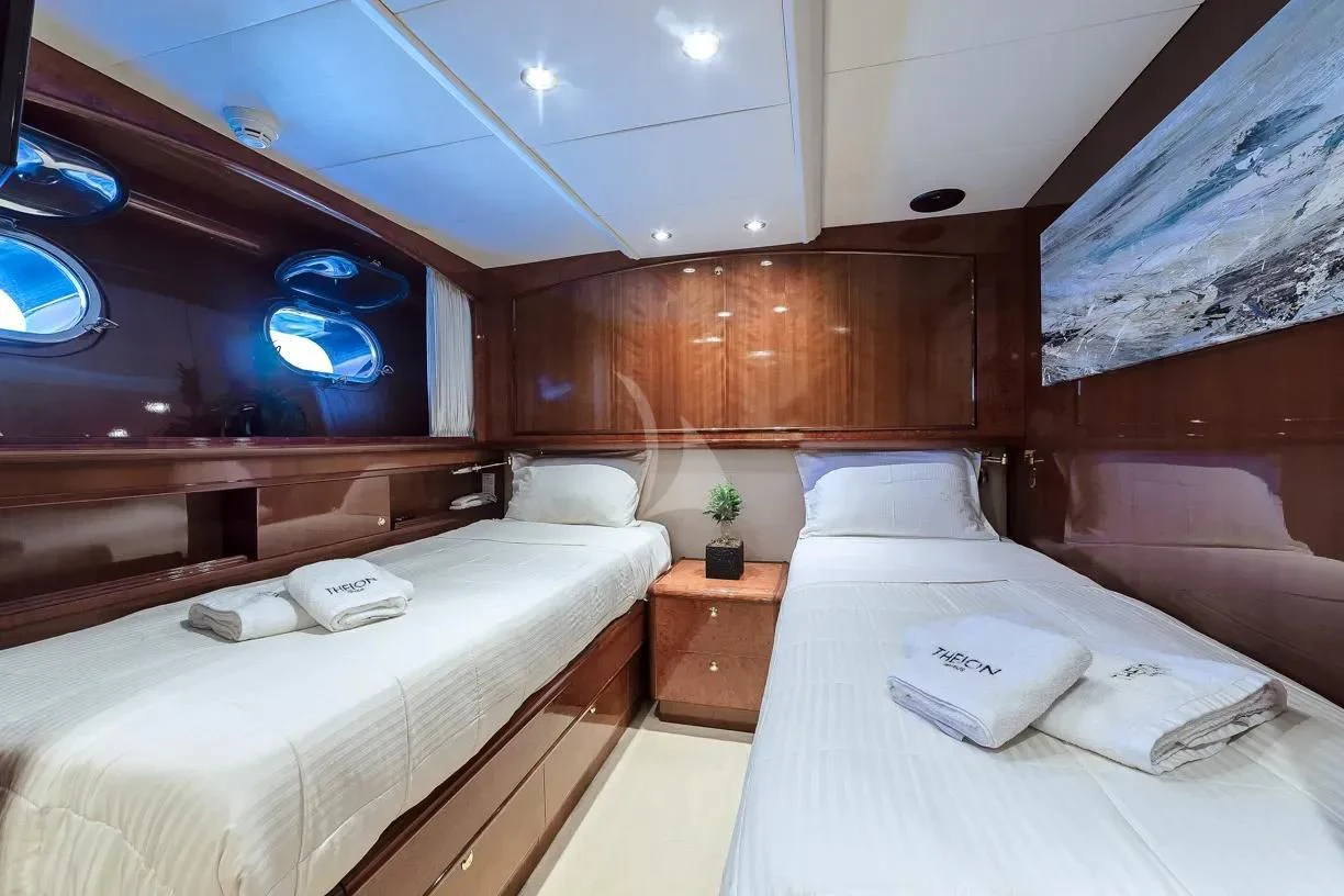 a room with two beds aboard THEION Yacht for Sale
