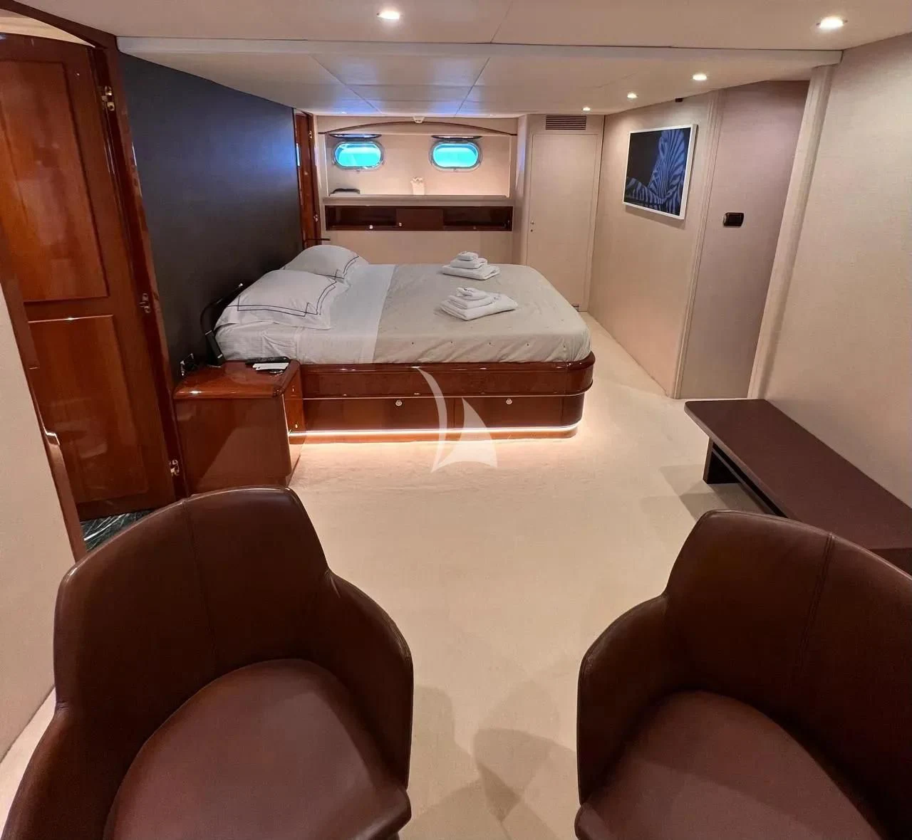 a room with a bed and a chair aboard THEION Yacht for Sale