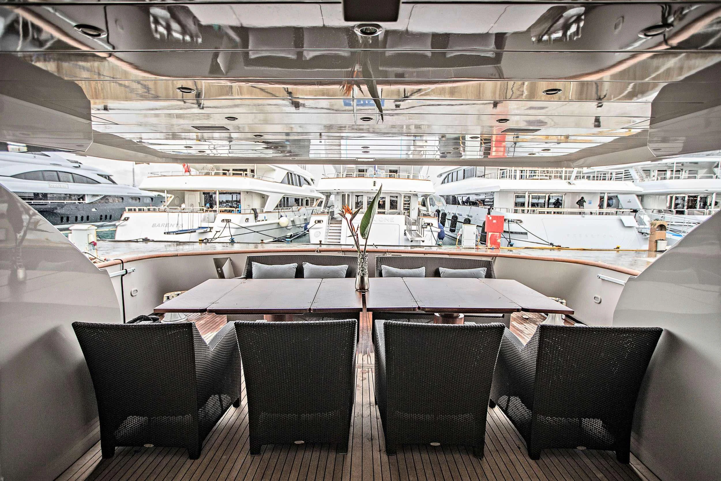 a room with chairs and tables aboard THEION Yacht for Sale
