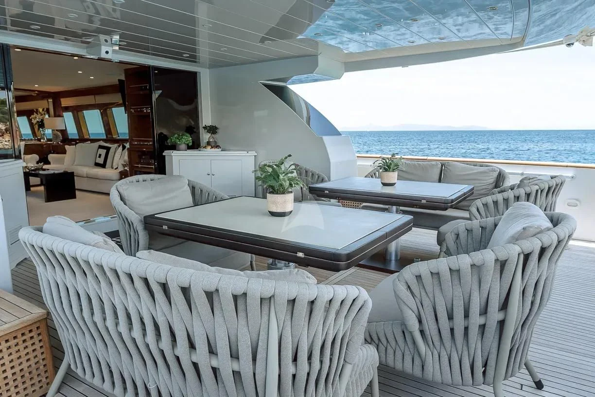 a room with a table and chairs aboard THEION Yacht for Sale