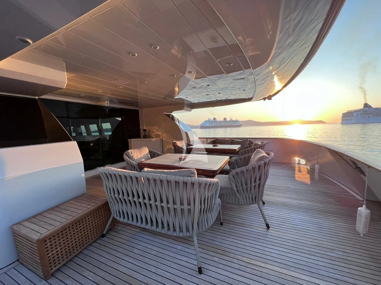 a table and chairs on a deck aboard THEION Yacht for Sale