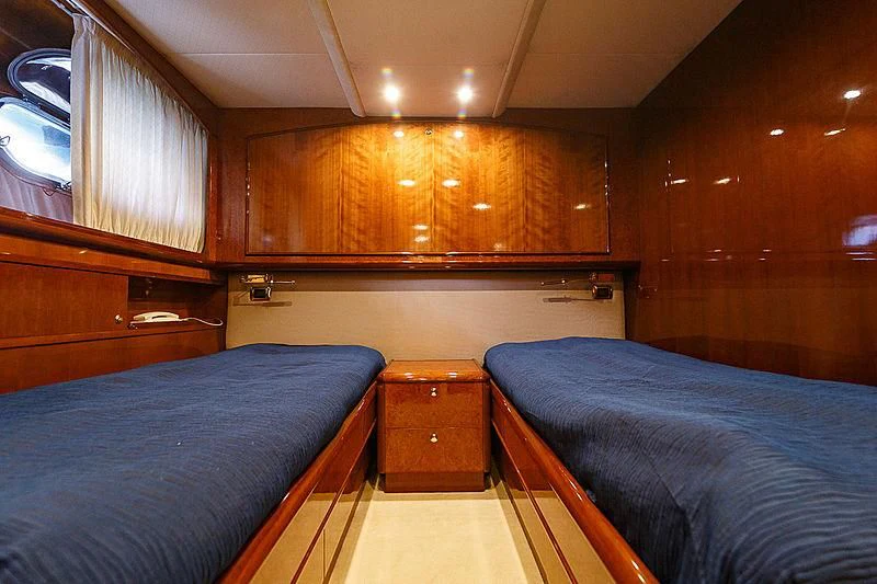 a couple of beds in a wooden cabin aboard THEION Yacht for Sale