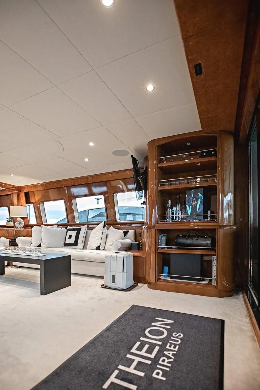 a room with a couch and a shelf with a rug aboard THEION Yacht for Sale