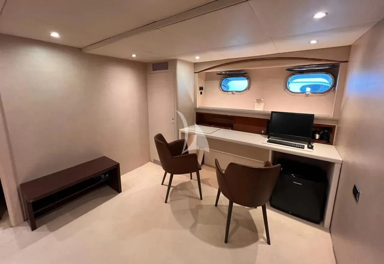 a room with a desk and chairs aboard THEION Yacht for Sale