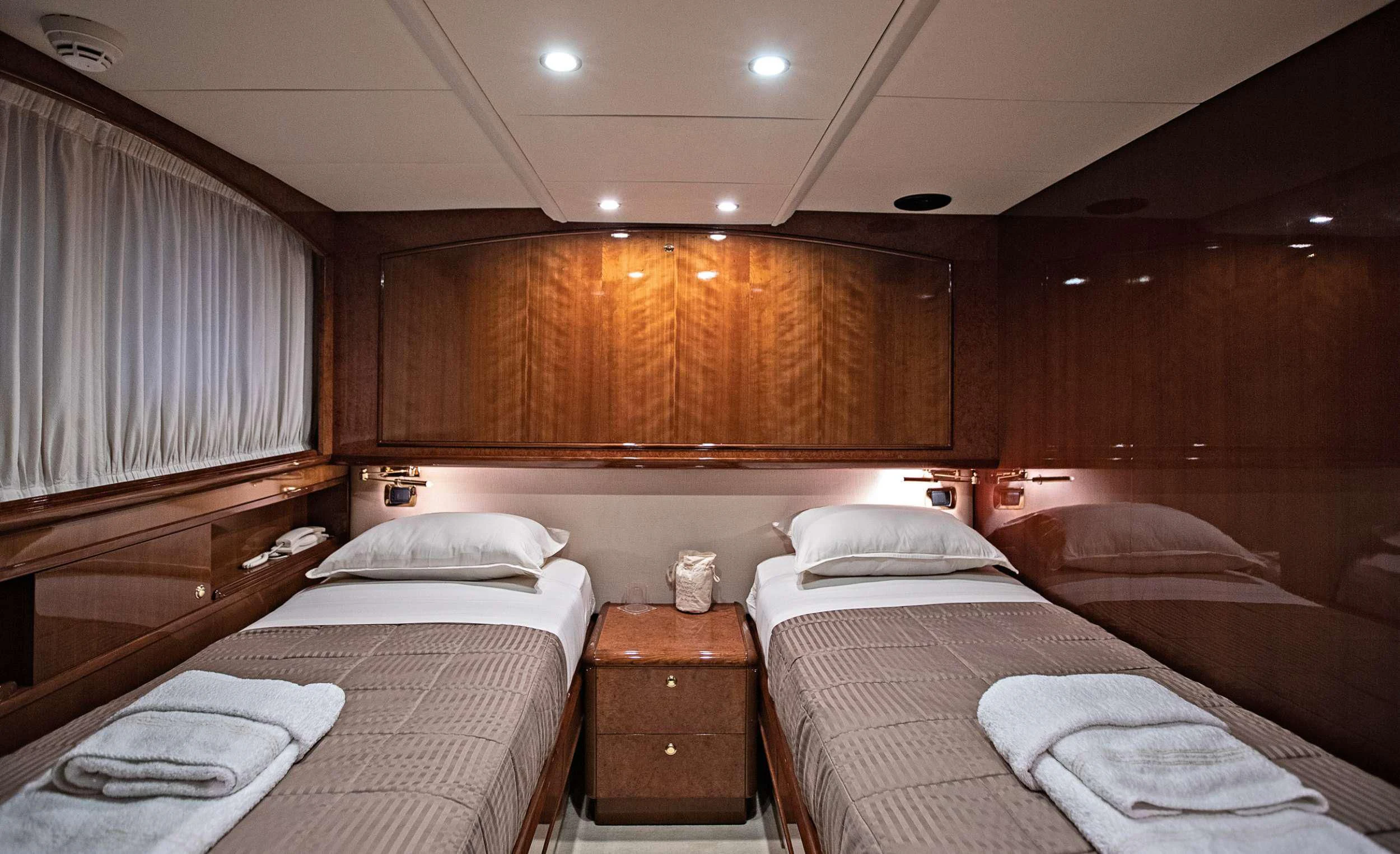 a room with a bed and a wood wall aboard THEION Yacht for Sale