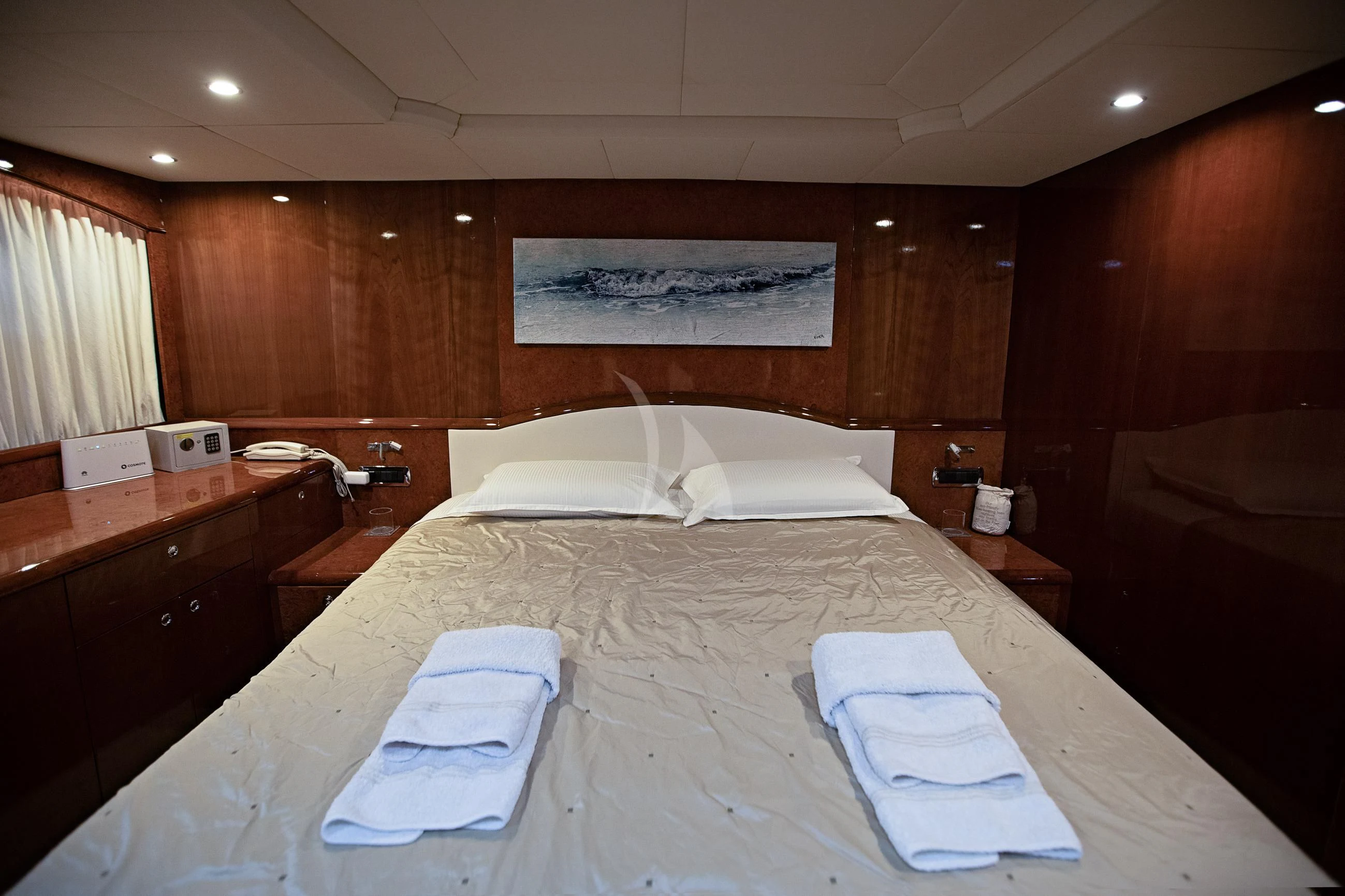 a bed with white sheets aboard THEION Yacht for Sale
