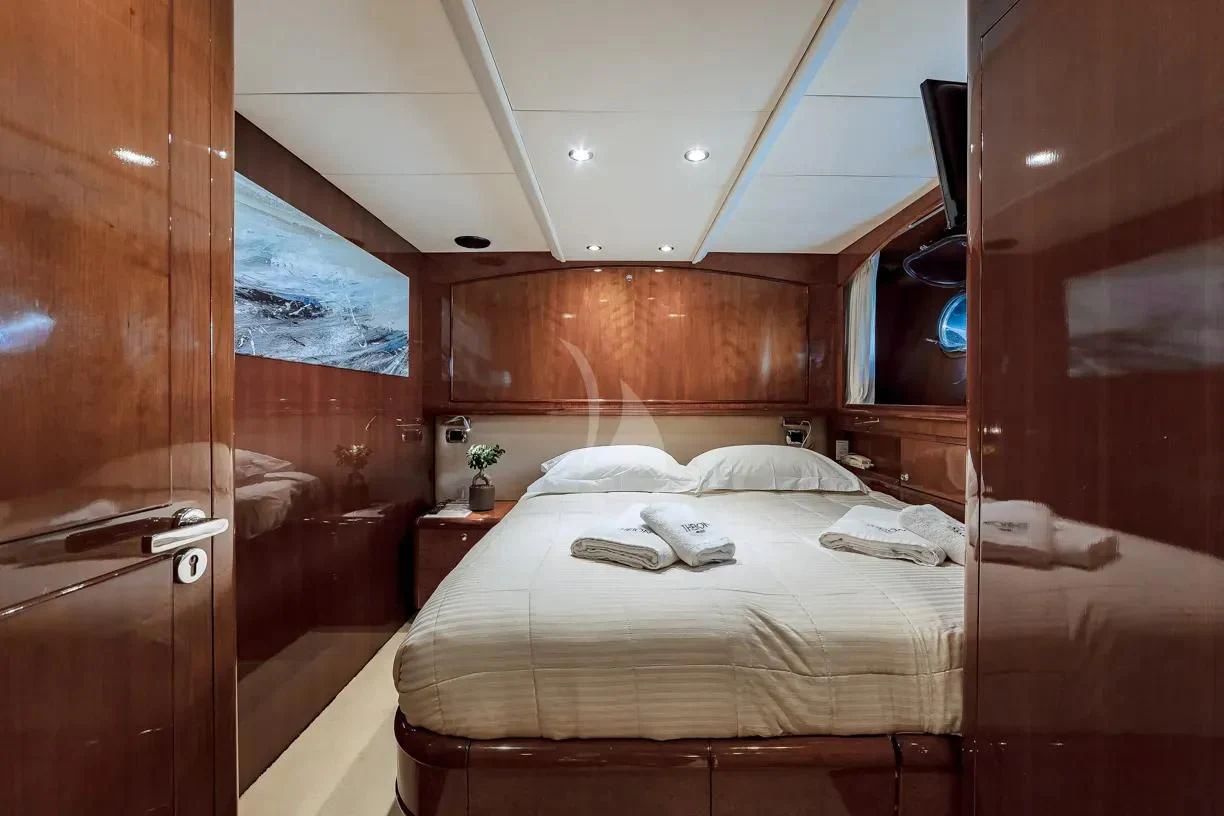 a room with a bed and a window aboard THEION Yacht for Sale