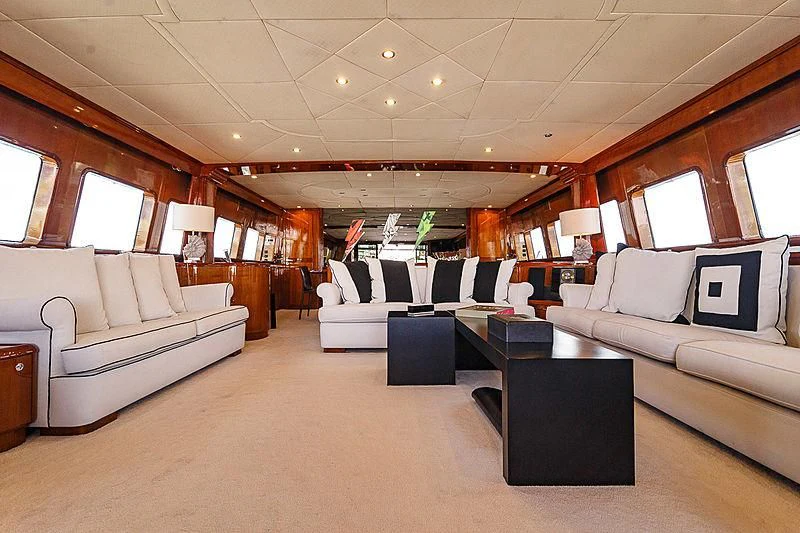 a large living room with white couches and a large window aboard THEION Yacht for Sale