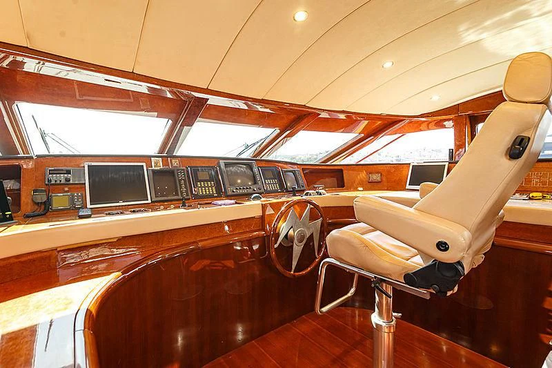 a wooden boat with a large wooden boat in the water aboard THEION Yacht for Sale