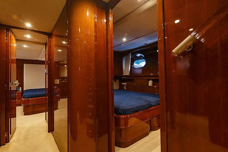 a room with a bed and a mirror aboard THEION Yacht for Sale