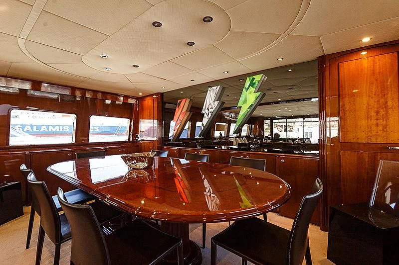 a restaurant with tables and chairs aboard THEION Yacht for Sale