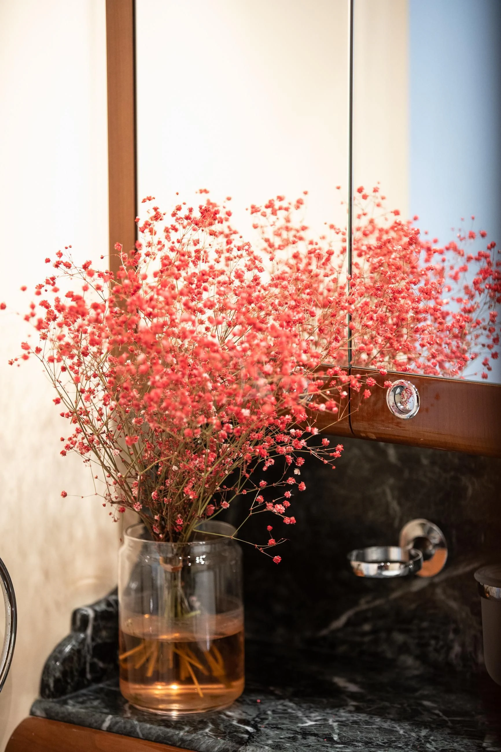 a vase with red flowers aboard THEION Yacht for Sale