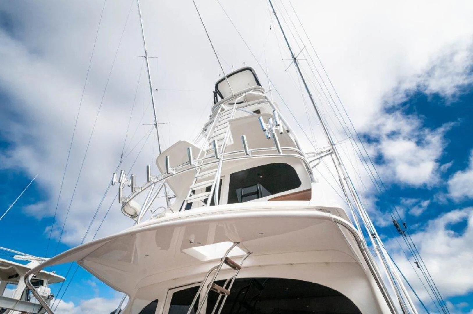 a white boat on a cloudy day aboard POUR INTENTIONS Yacht for Sale