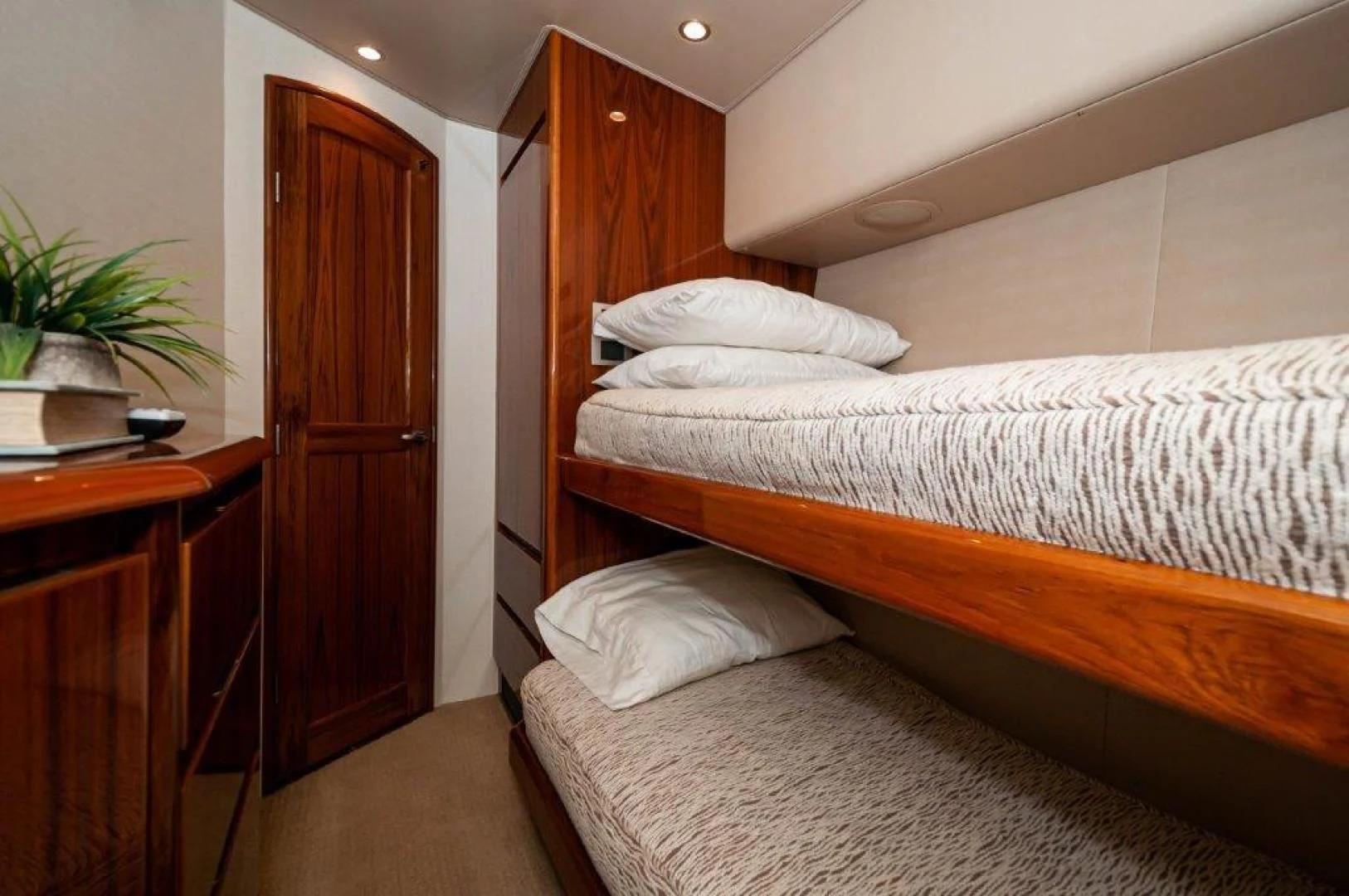 a bedroom with a bed and a door aboard POUR INTENTIONS Yacht for Sale