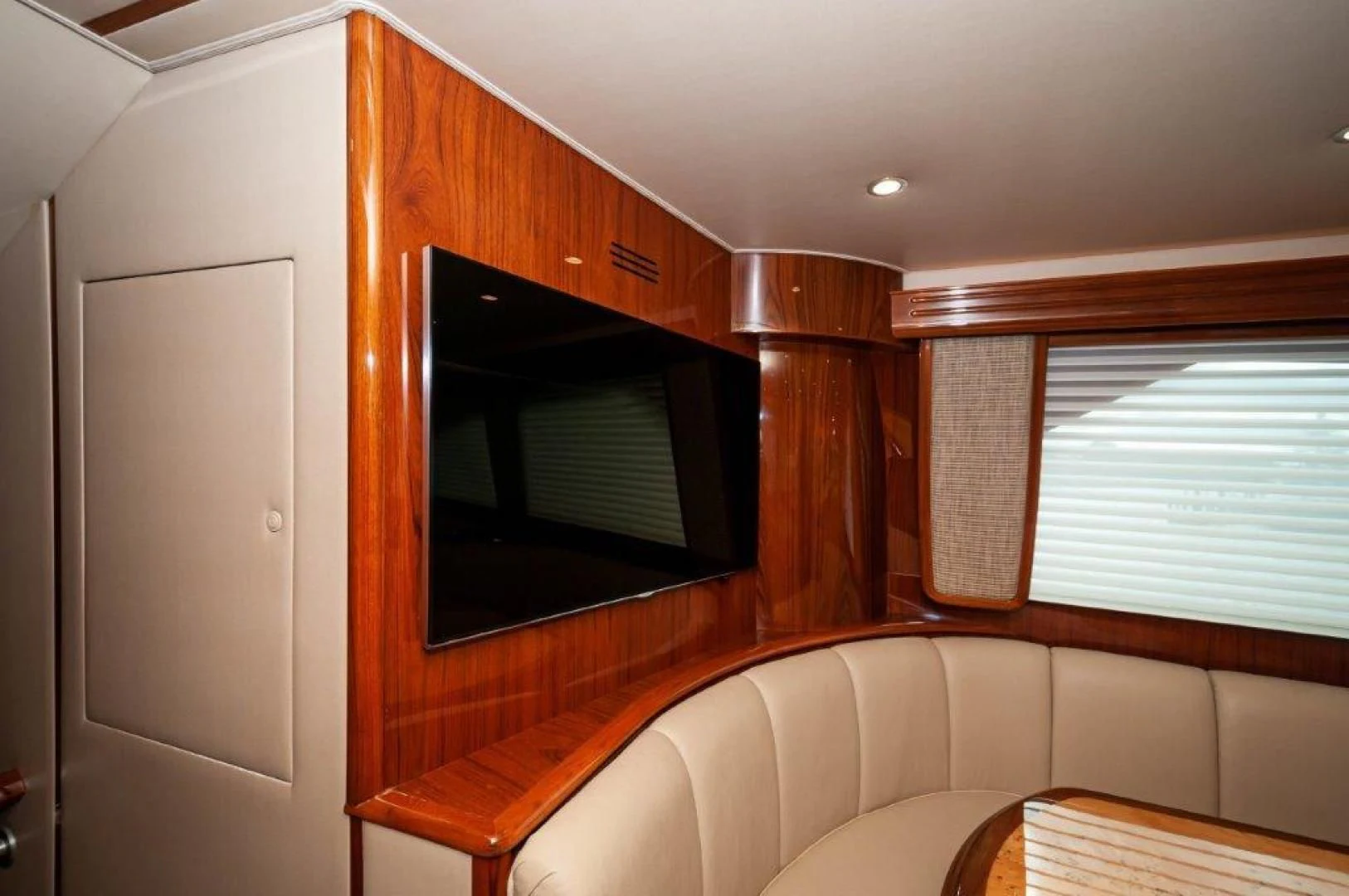 a living room with a couch and a television aboard POUR INTENTIONS Yacht for Sale